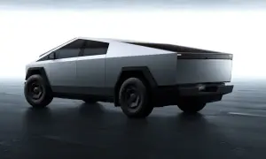 Futurystyczny Tesla Cybertruck w kolorze srebrnym, z ostrymi krawędziami. Zastanawiasz się nad jego tesla cybertruck cena?