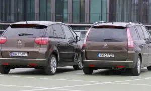Dwa brązowe Citroen Picasso stoją obok siebie na parkingu.