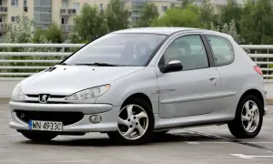 Srebrny Peugeot 206 1.4 benzyna z polskimi tablicami rejestracyjnymi na parkingu.