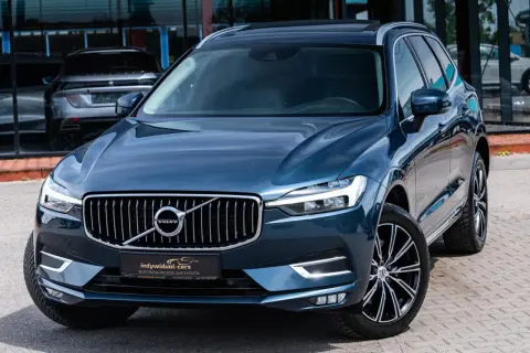 Elegancki, ciemnoniebieski SUV Volvo z chromowanym grillem. Idealny wybór dla szukających auta do 60 tys.
