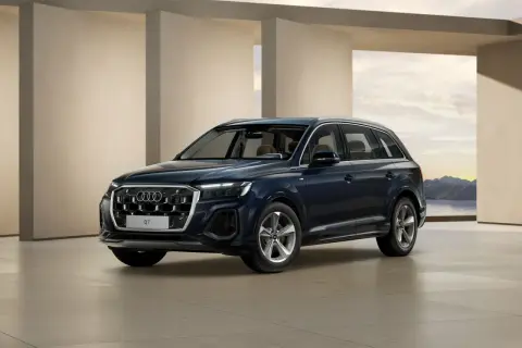 Eleganckie, ciemnogranatowe nowe Audi Q7 prezentuje się na tle nowoczesnej architektury i malowniczego krajobrazu.