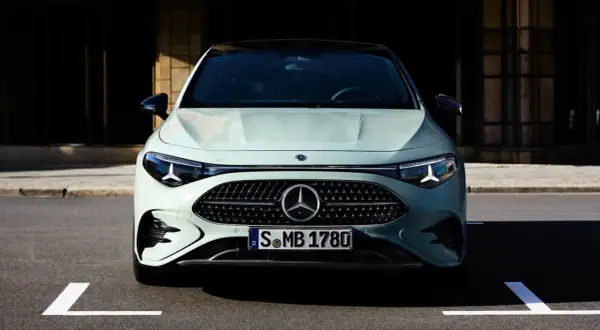 Przód eleganckiego, jasnoszarego Mercedesa CLA 2025 z charakterystycznym grillem i światłami LED.