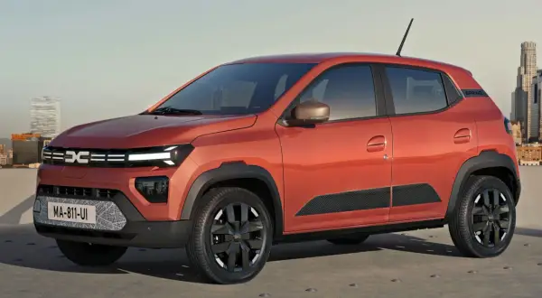 Pomarańczowy Dacia Spring, elektryczny samochód miejski. Sprawdź atrakcyjną dacia spring cena i zacznij podróżować ekologicznie.