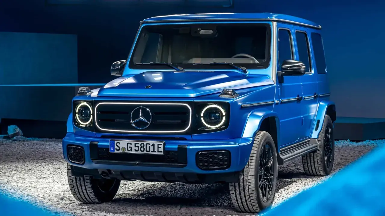 Niebieski Mercedes G-klasa, ikoniczny jeep, prezentuje się imponująco na tle niebieskiego tła.