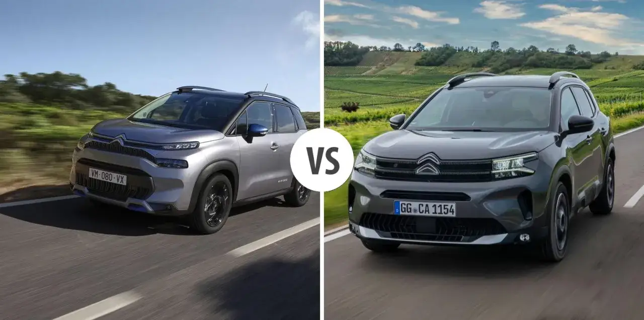 Dwa modele Citroen SUV: jeden srebrny, drugi ciemnoszary, jadące po drodze.