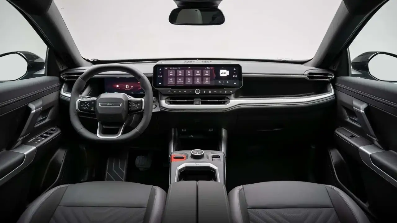 Wnętrze Jeep Compass 2025: nowoczesna deska rozdzielcza z dużym ekranem dotykowym, cyfrowy kokpit i skórzana kierownica.