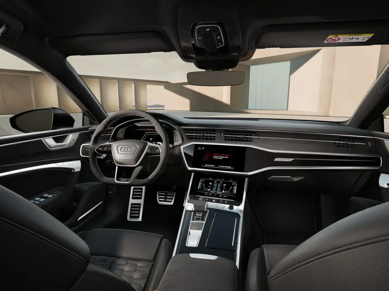 Wnętrze Audi RS 7 z nowoczesnym kokpitem, cyfrowymi ekranami i sportową kierownicą.
